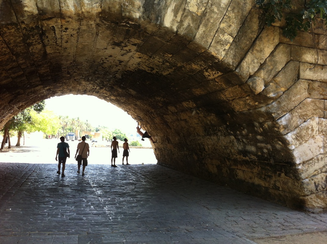 locals rockclimbing on the tunnels over the boardwalk along the river Guadalquivir. 
